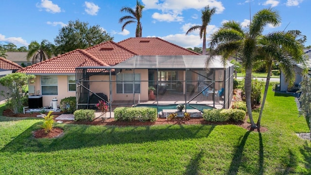 rear view of house with a patio, a lanai, and a yard