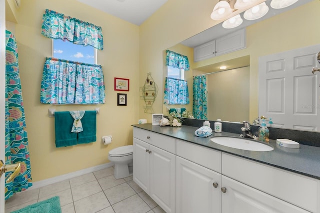 bathroom featuring baseboards, a shower with shower curtain, toilet, tile patterned flooring, and vanity