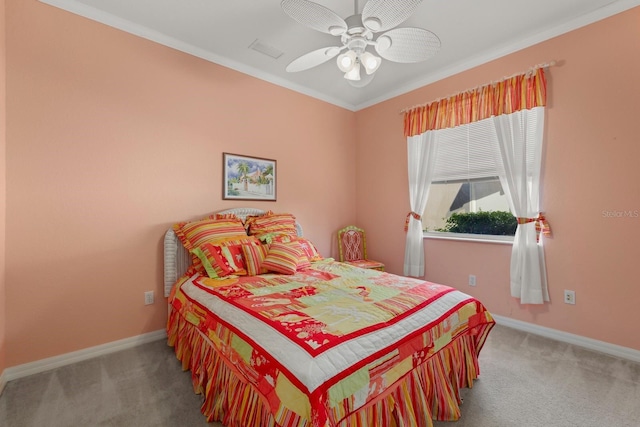 carpeted bedroom with a ceiling fan, crown molding, and baseboards