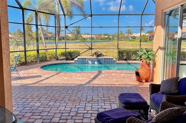 outdoor pool with glass enclosure and a patio area