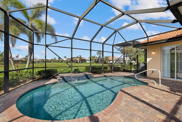 outdoor pool with glass enclosure and a patio area