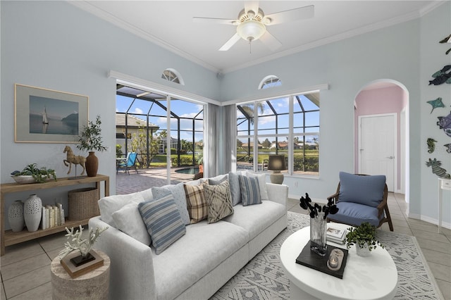 living area featuring light tile patterned floors, ceiling fan, a sunroom, and crown molding