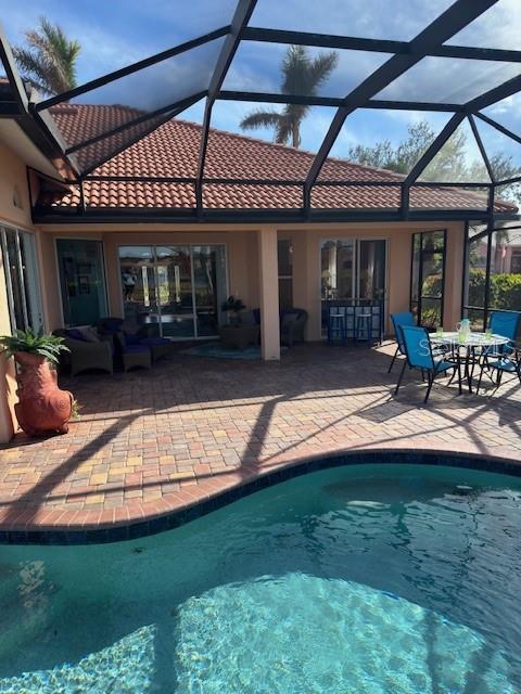 pool featuring a lanai and a patio area