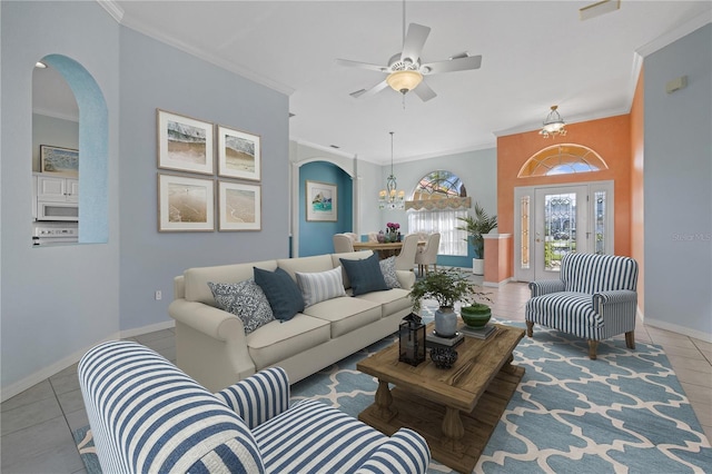 living room with baseboards, arched walkways, tile patterned flooring, and crown molding