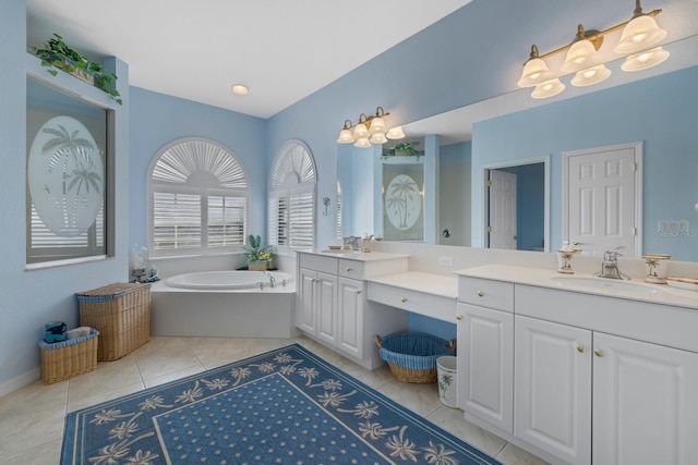 full bath with tile patterned flooring, two vanities, a sink, and a garden tub