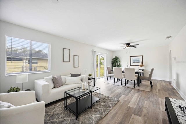 living room featuring hardwood / wood-style floors and ceiling fan