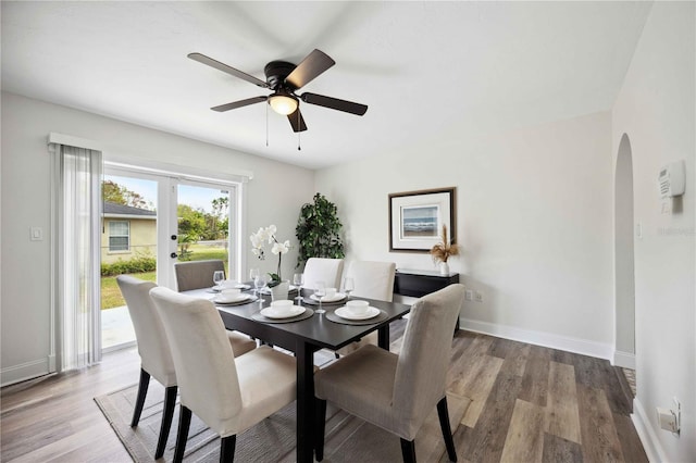 dining space with light hardwood / wood-style floors and ceiling fan