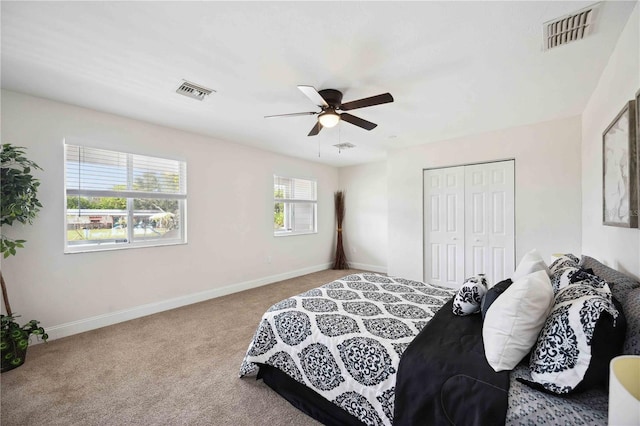 bedroom with light carpet, a closet, and ceiling fan