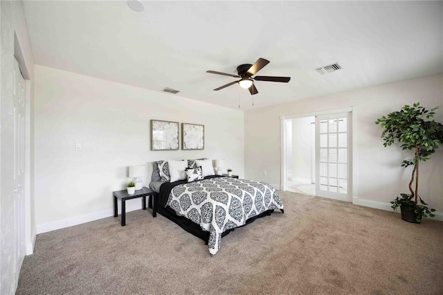 carpeted bedroom with ensuite bathroom and ceiling fan