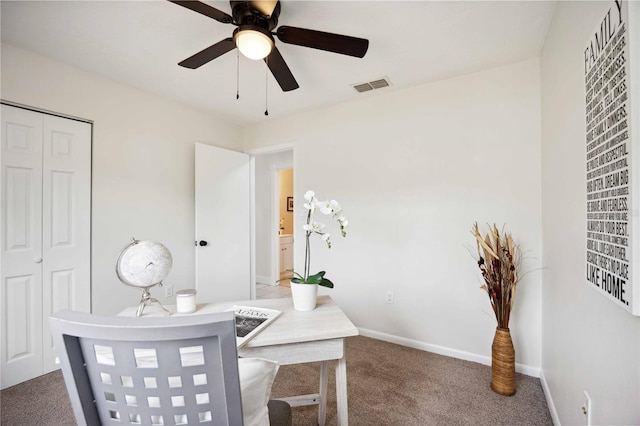 carpeted home office with ceiling fan