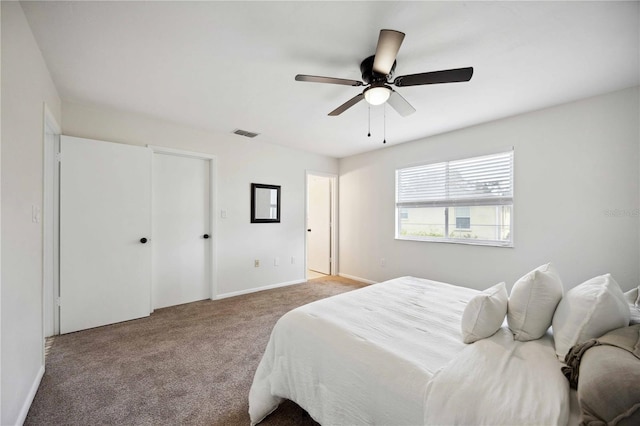 bedroom with ceiling fan and light colored carpet