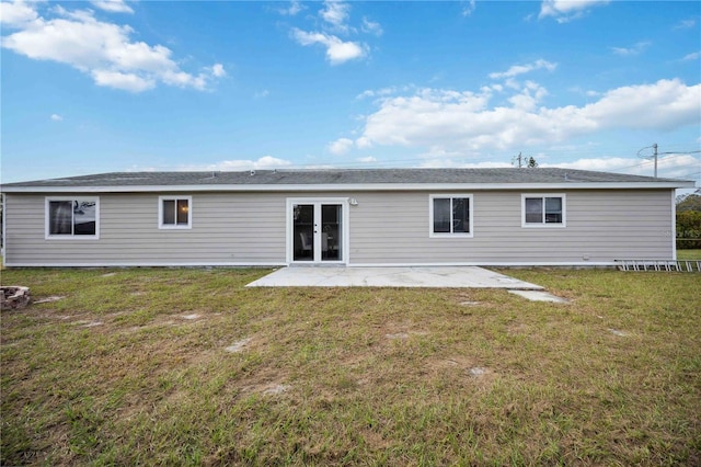 back of property featuring a lawn and a patio area