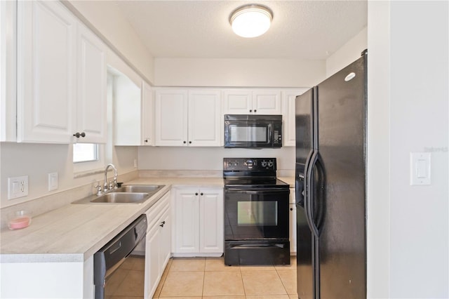 kitchen featuring black appliances, white cabinets, sink, light tile patterned floors, and a textured ceiling