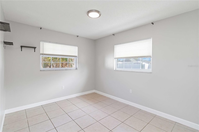 spare room with light tile patterned floors