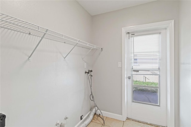 clothes washing area featuring hookup for a gas dryer, light tile patterned floors, and hookup for a washing machine