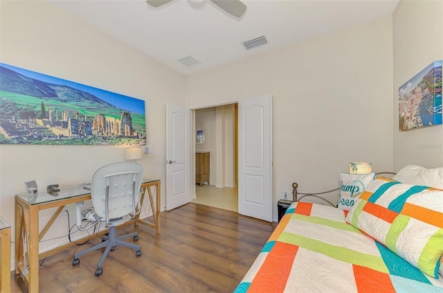 bedroom with ceiling fan and dark wood-type flooring