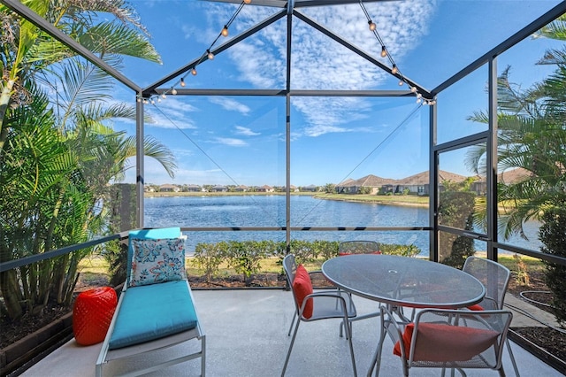 sunroom / solarium featuring plenty of natural light and a water view