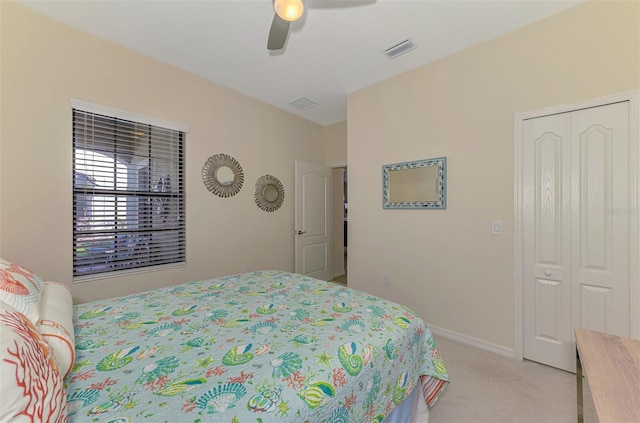 carpeted bedroom featuring a closet and ceiling fan