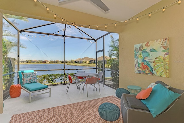 view of patio / terrace featuring a lanai and a water view