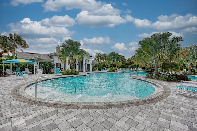 view of pool with a patio area and pool water feature