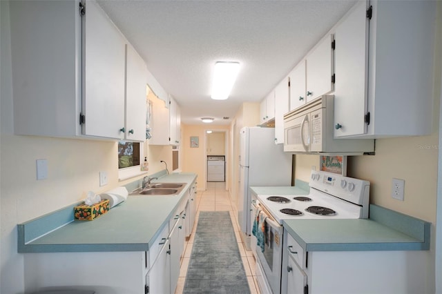 kitchen featuring sink, white cabinets, a textured ceiling, white appliances, and light tile patterned flooring