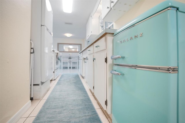 hall featuring light tile patterned floors