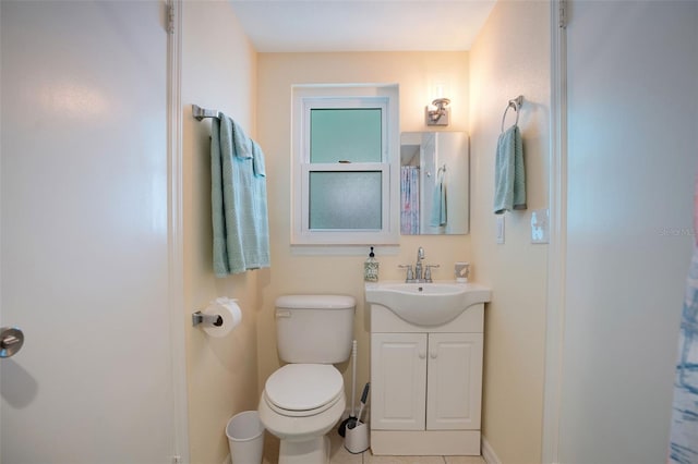 bathroom featuring tile patterned flooring, vanity, and toilet