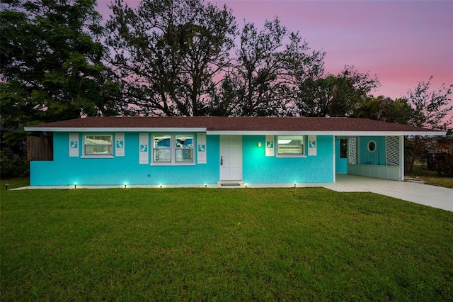 ranch-style home featuring a lawn