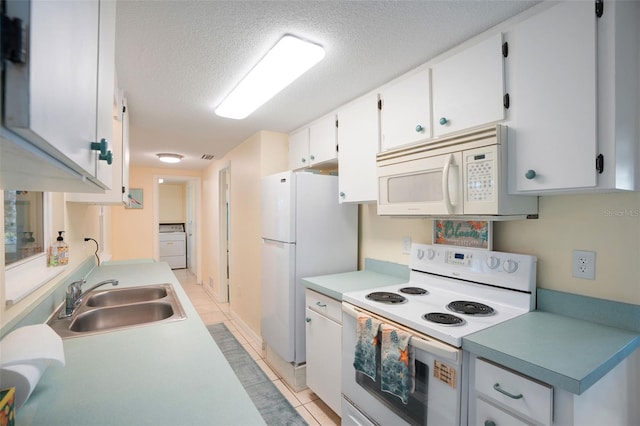 kitchen featuring sink, white appliances, white cabinetry, and light tile patterned floors