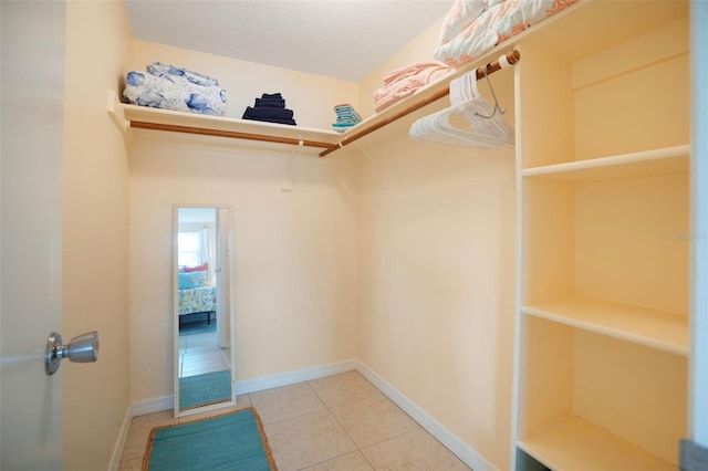 spacious closet with light tile patterned floors