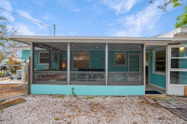 rear view of property with a sunroom