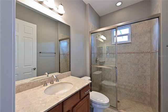 bathroom with an enclosed shower, vanity, and toilet