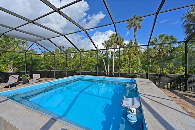 view of swimming pool with a patio and a lanai