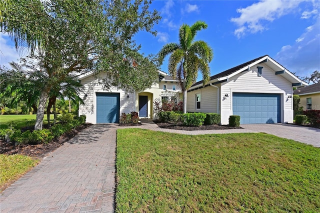 single story home with a front lawn and decorative driveway