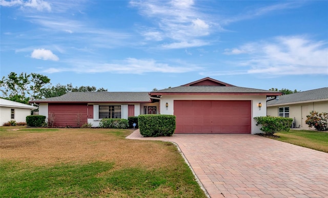 single story home with a garage and a front yard