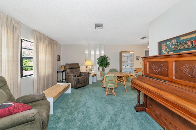 living area with light carpet and a textured ceiling