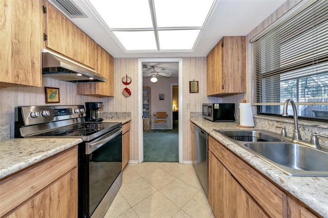 kitchen featuring stainless steel appliances, ceiling fan, sink, exhaust hood, and light tile patterned floors