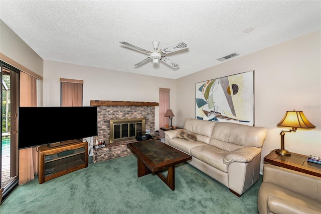 living room featuring a textured ceiling, a brick fireplace, and a wealth of natural light