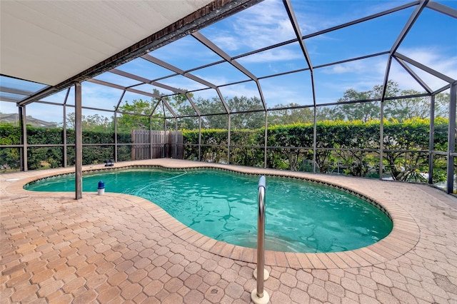 view of swimming pool with a lanai and a patio