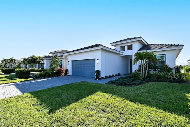 view of front of home with a front yard and a garage