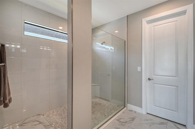 bathroom with tiled shower