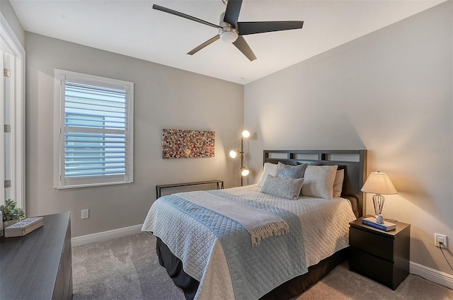 bedroom with ceiling fan, carpet floors, and multiple windows