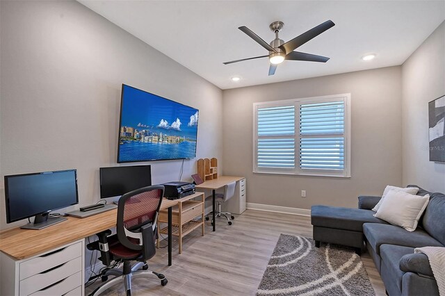 home office with ceiling fan and light wood-type flooring