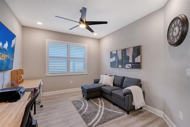 home office with ceiling fan and light hardwood / wood-style floors