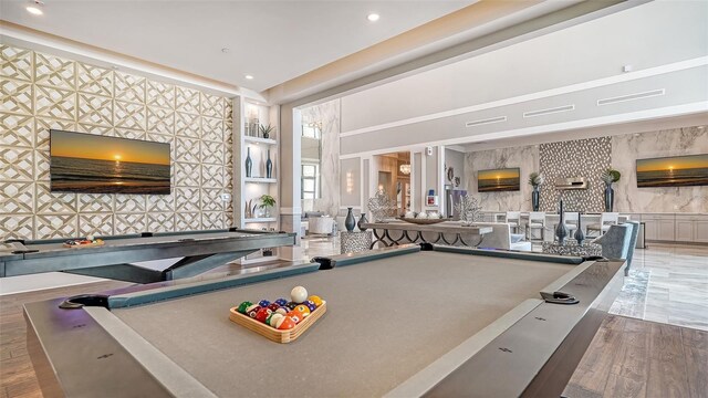 recreation room featuring built in shelves, hardwood / wood-style flooring, and pool table