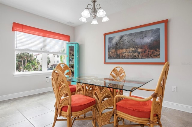 dining area featuring light tile patterned flooring and a chandelier