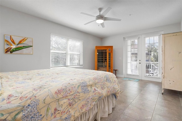 bedroom with french doors, access to outside, light tile patterned floors, and ceiling fan