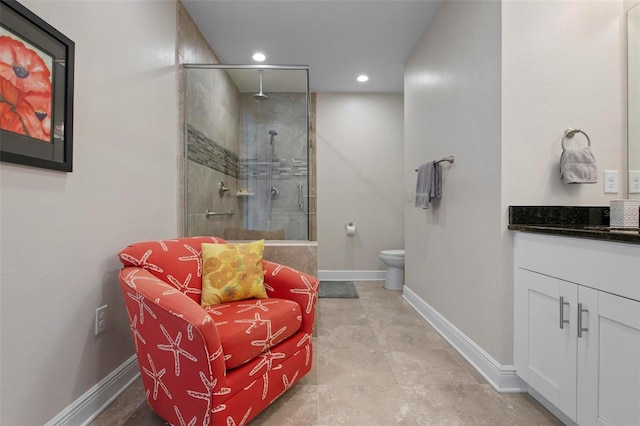 bathroom with vanity, toilet, and an enclosed shower