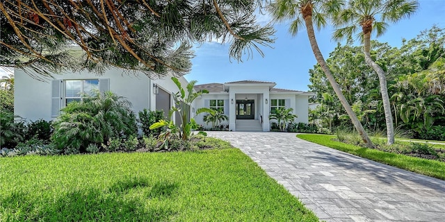 mediterranean / spanish-style home with a front lawn