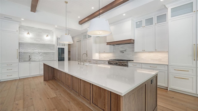 kitchen with white cabinets and a large island with sink